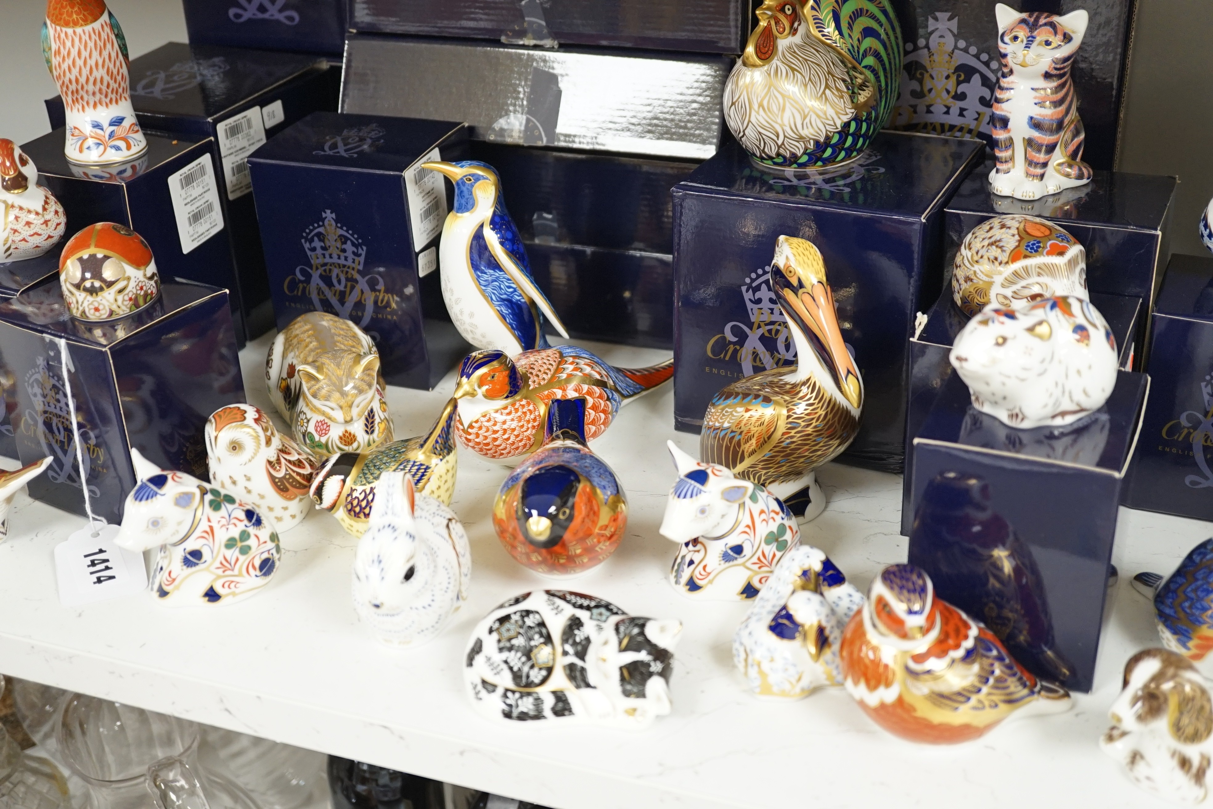 Approximately thirty-two Royal Crown Derby Imari porcelain paperweights, all but two with original boxes and mostly gold bottoms